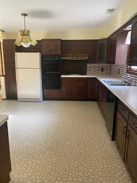 Dated kitchen before remodeling with old cabinets