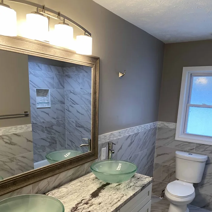 Remodeled bathroom with a tiled shower and new vanity