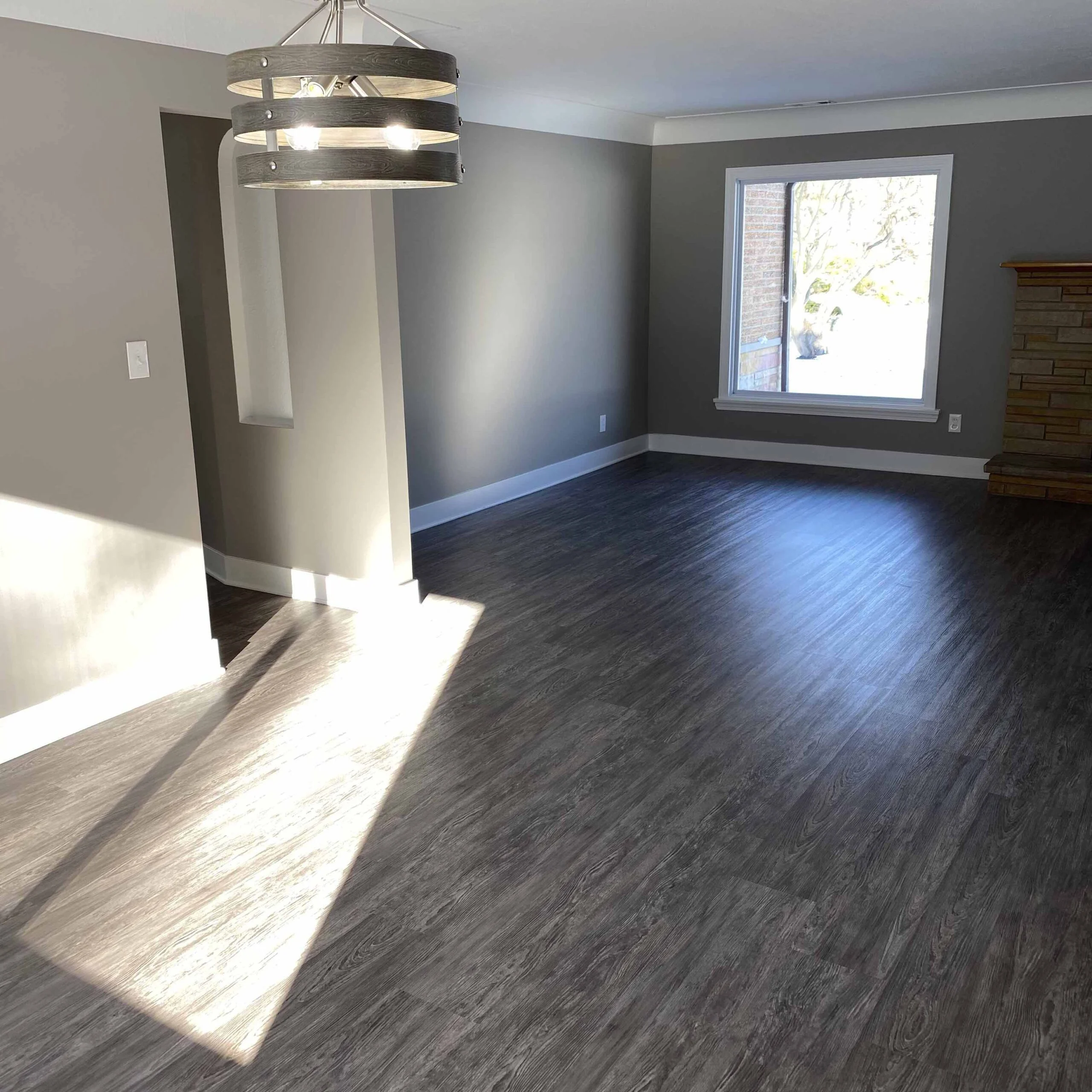 Finished living room with new flooring and trim